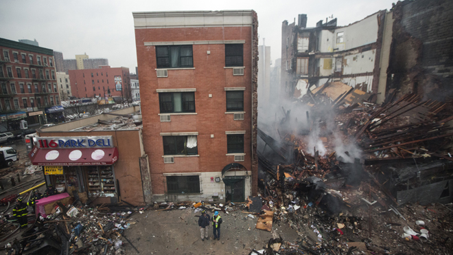 New York City emergency responders work at the site of a building explosion and collapse in the Harlem section of New York