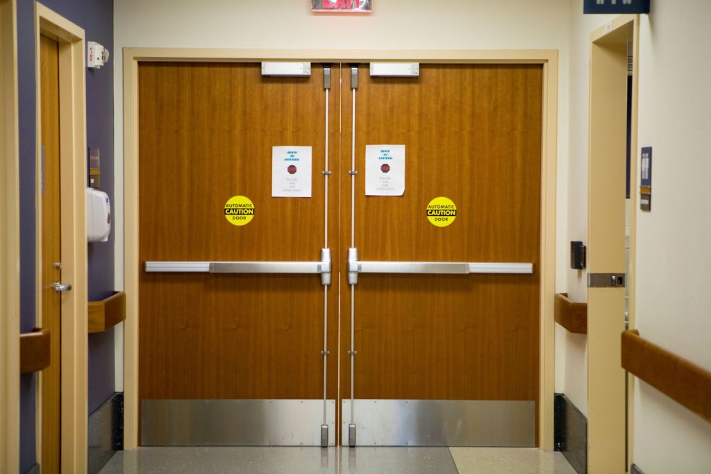 A delayed egress lock is a type of electrified hardware that prevents egress for 15 seconds (or 30 seconds where allowed by the Authority Having Jurisdiction (AHJ)).  When a building occupant attempts to exit through a door equipped with a delayed egress lock, an alarm will sound and the door will remain locked; signage is required to be mounted on the door explaining the operation of the lock.  When the time delay is complete, the door may then be opened by normal operation of the hardware, to allow building occupants to exit.  If there is a fire alarm or power failure, the delayed egress lock must allow immediate egress with no delay.  The products commonly used for delayed egress applications include panic hardware / fire exit hardware or electromagnetic locks that incorporate delayed egress circuitry..