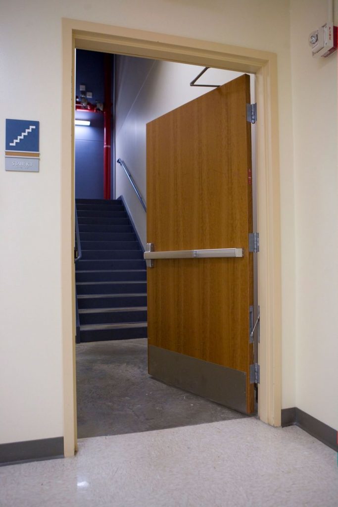 Egress doors are typically required to swing in the direction of egress when they're serving an occupant load of 50 people or more, but there are a few other locations where doors are required to be outswinging even if they are serving a lower occupant load.  There are also some situations where egress doors are not required to be swinging doors, and may be another type of door such as a horizontal sliding door or revolving door.