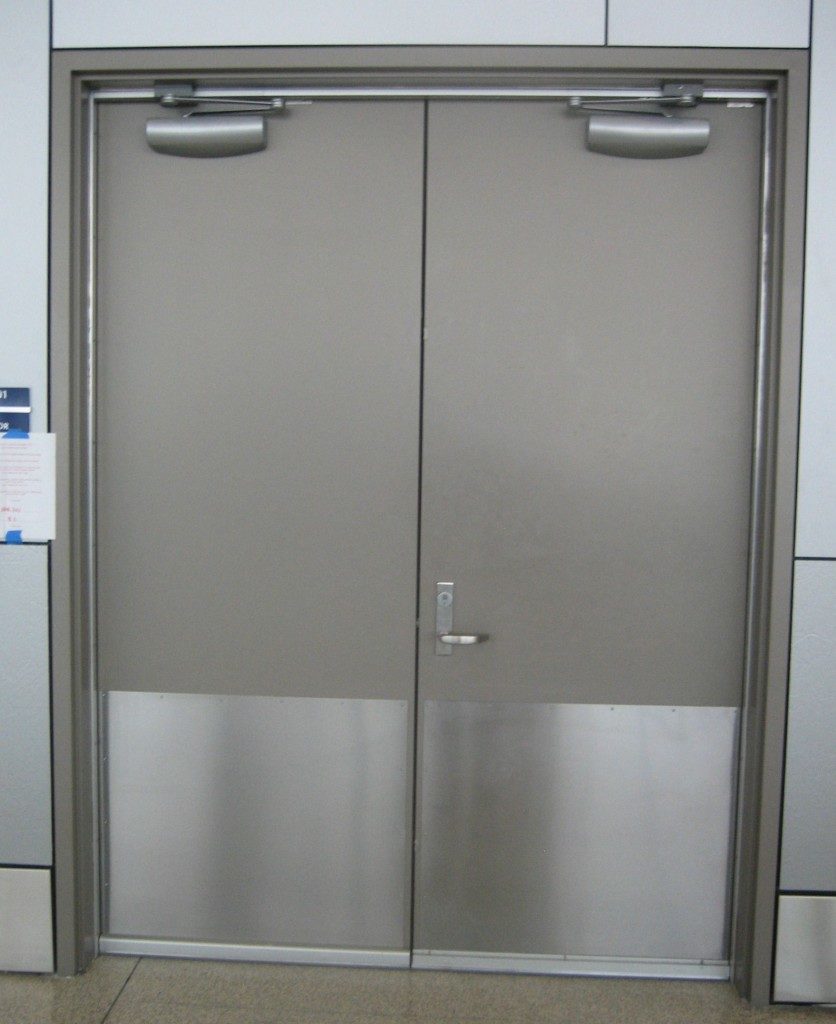 NFPA 80 - Standard for Fire Doors and Other Opening Protectives includes limitations on protection plates installed on fire doors. The purpose of these requirements is to address the installation of kick plates, armor plates, or stretcher plates that could otherwise affect the performance of the fire door assembly if a fire occurs.
