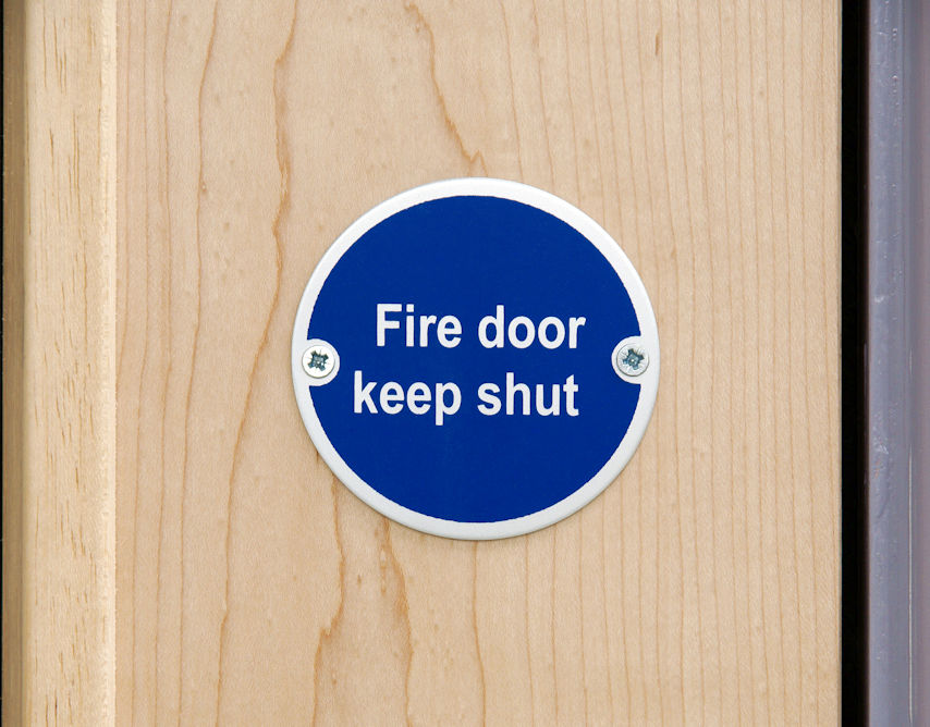 The 2022 edition of NFPA 80 includes some important changes related to the size and attachment methods for signage on fire doors.  Can you spot what's new in the updated standard?