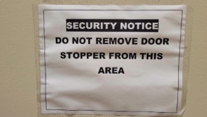 Sign noting to not remove door stop