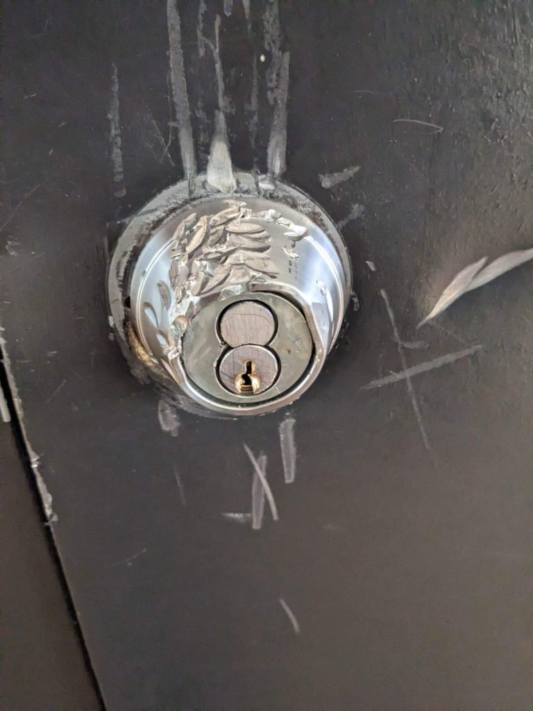 damage to a Schlage deadbolt caused by students trying to remove a broken key