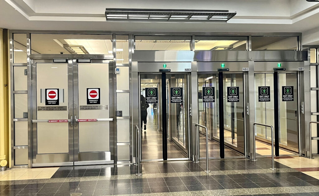 Yesterday in an airport I saw a bank of interlocks and an adjacent pair of doors with delayed egress locks.  What do you think about this application?  Do some AHJs require delayed egress doors where interlocks are installed?  WWYD?