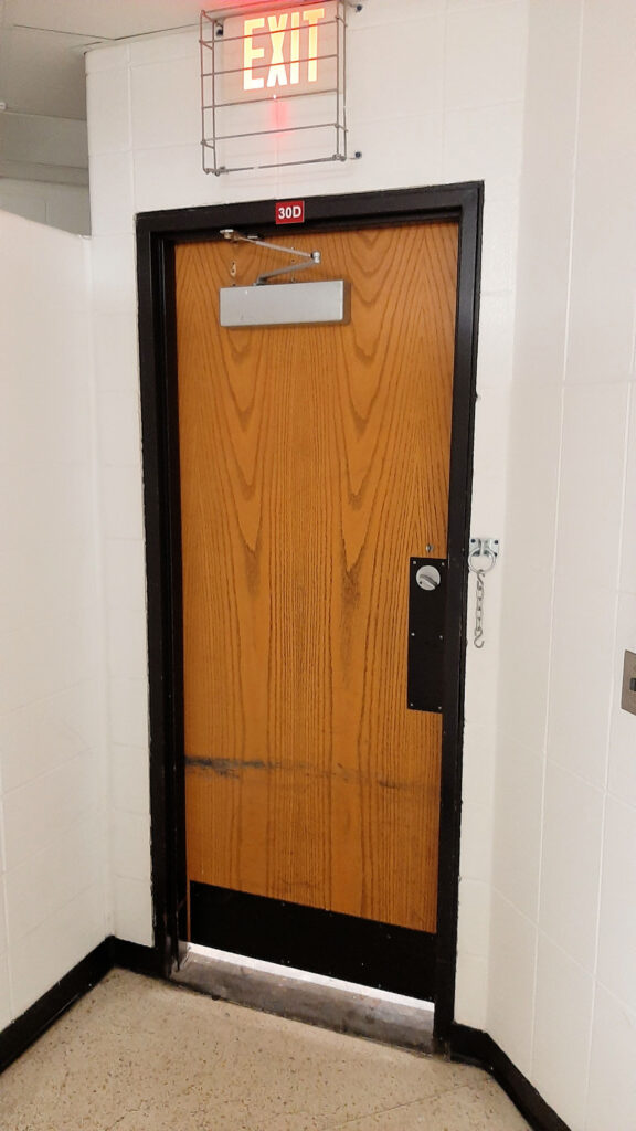 Chain locking mechanism on egress door in a school