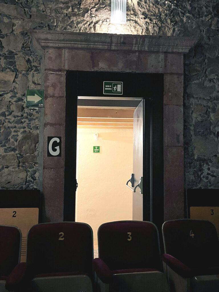New egress door in a stone library auditorium