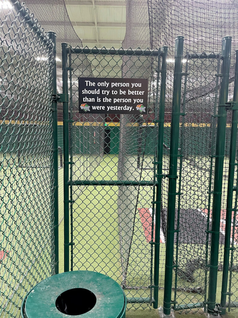 partially blocked egress swinging the wrong way in a batting practice facility