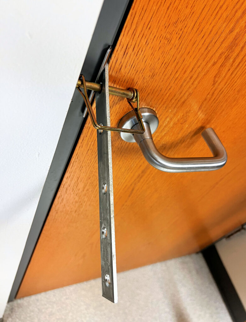 Today's Fixed-it Friday photos illustrate another barricade device used to secure a classroom door.  I don't recommend this method or any other device that impacts egress, is non-compliant with the ADA, and is untested for security.