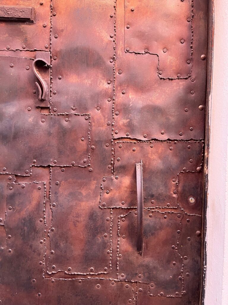 I love how one of the doors in today's post was designed as a stylized version of something that is very common here - old doors that have been repaired numerous times over the decades.  