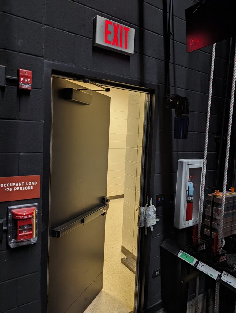 Every time I go backstage in a school auditorium, I see issues with the egress doors.  Any ideas about what could have been done differently with this door?