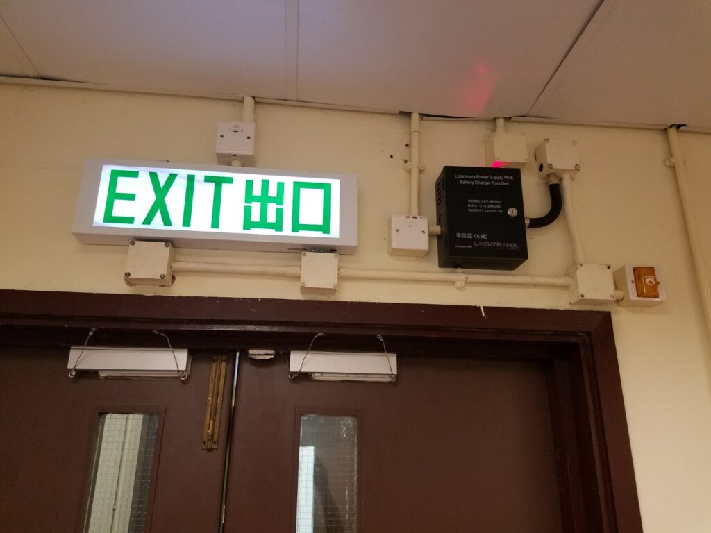 Tim Chow sent me today's Fixed-it Friday photo of a pair of doors with access control, and I can't figure out what those little wires are for.  Any ideas?