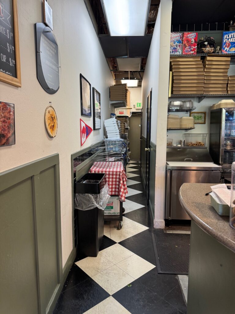 I know we have seen MANY of these blocked egress photos, but this one is pretty egregious.  What I'm wondering is...are there no AHJs who eat here? 