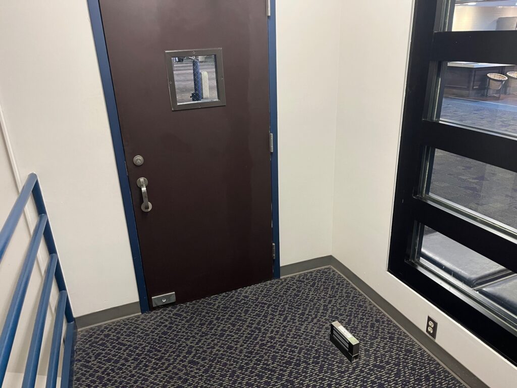 I have occasionally seen mag-locks used to hold doors open, but not typically on the floor where they become a major tripping hazard!