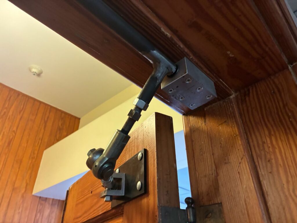 John Danes of Allegion shared these Fixed-it Friday photos recently and I'm still wondering what the purpose of this hardware is.  Any ideas?